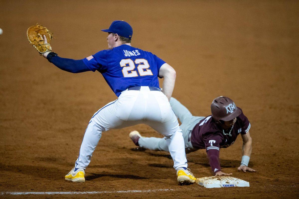 LSU baseball sophomore first basemen Jared Jones (22) catches the ball to tag during LSU's 6-4 win on Saturday, May 4, 2024, at Alex Box Stadium in Baton Rouge, La.