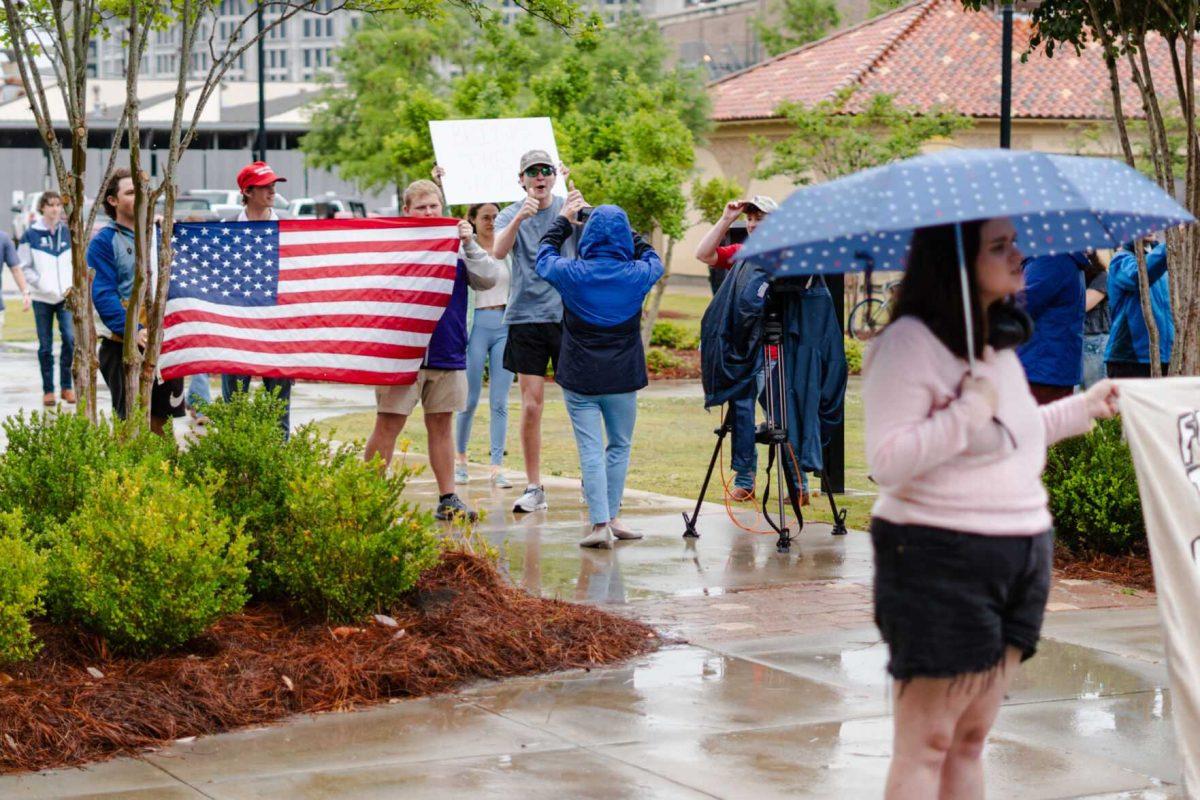 Counter-protesters hold up an American flag Friday, May 3, 2024, outside of Patrick F. Taylor Hall on LSU's campus in Baton Rouge, La.