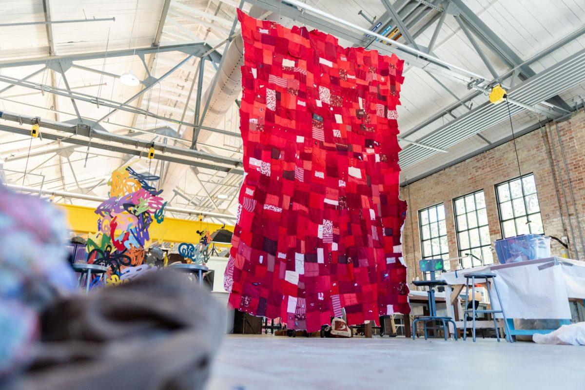 A quilt where each patch represents a report filed with the LSU Title IX office hangs Wednesday, May 1, 2024, inside the Barnes Ogden Art &amp; Design Complex on LSU's campus in Baton Rouge, La.