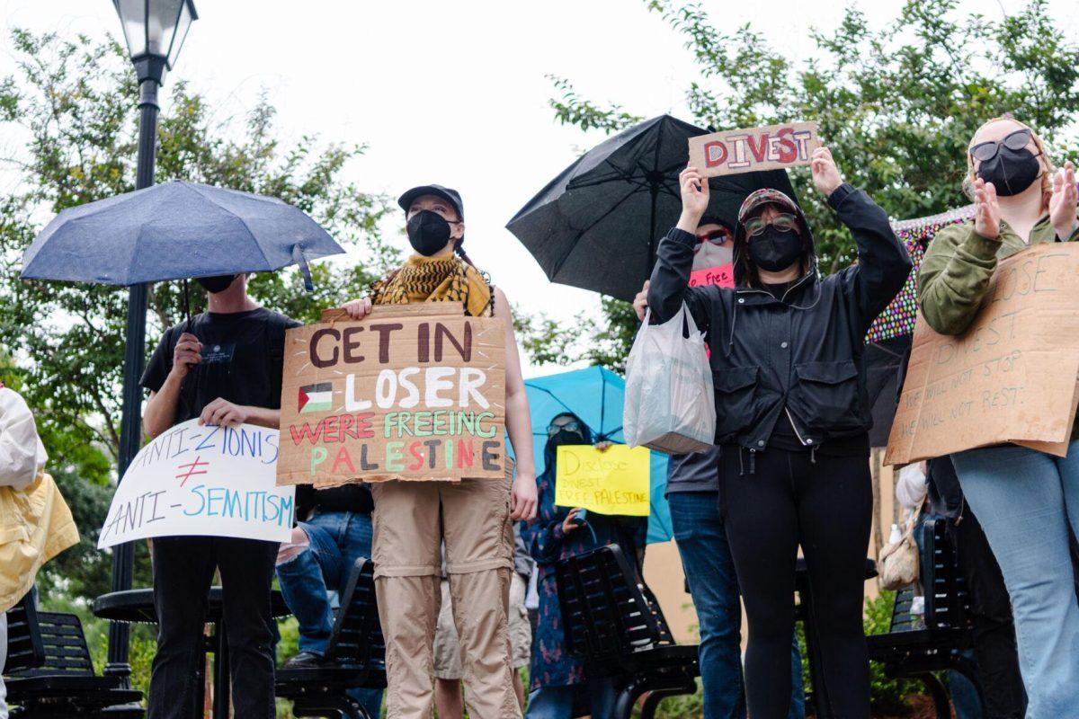 Pro-Palestinian protesters hold various signs Friday, May 3, 2024, outside of Patrick F. Taylor Hall on LSU's campus in Baton Rouge, La.