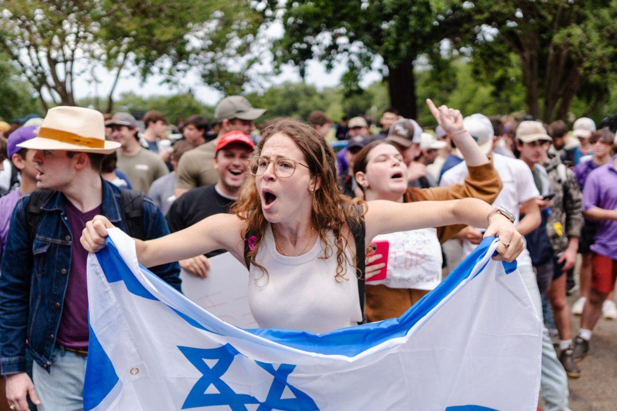 Counter-protester Hannah Poltorak waves an Israeli flag Friday, May 3, 2024, in Free Speech Alley on LSU's campus in Baton Rouge, La.