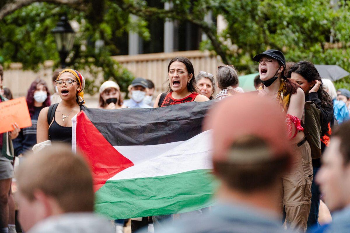 Pro-Palestinian protesters chant and hold a Palestinian flag Friday, May 3, 2024, on the Student Union steps on LSU's campus in Baton Rouge, La.