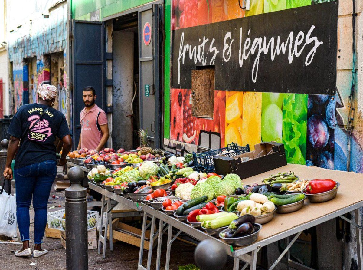 Locals purchase fruits and vegetables at a stand in Marseille, France on Monday, July 22, 2024.