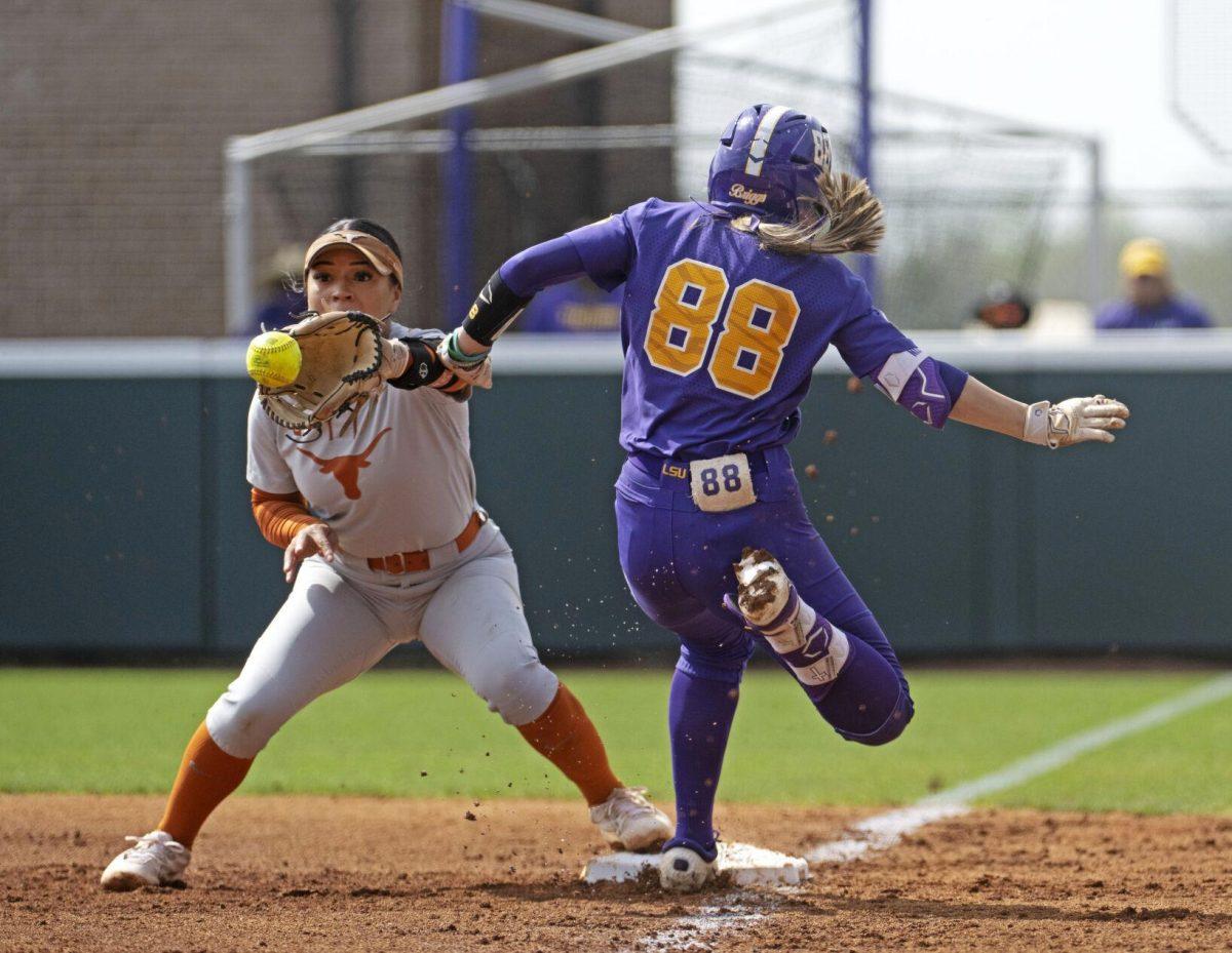 LSU's Ciara Briggs (88) is safe at first as Texas first baseman Joley Mitchell (9) awaits the throw during an NCAA college softball game Tuesday, March 12, 2024, in Baton Rouge, La. (Hilary Scheinuk/The Advocate via AP)