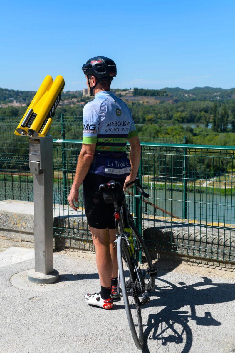 Biker admires view after making it to top of hill in Avignon, France on Wednesday, July 24, 2024.