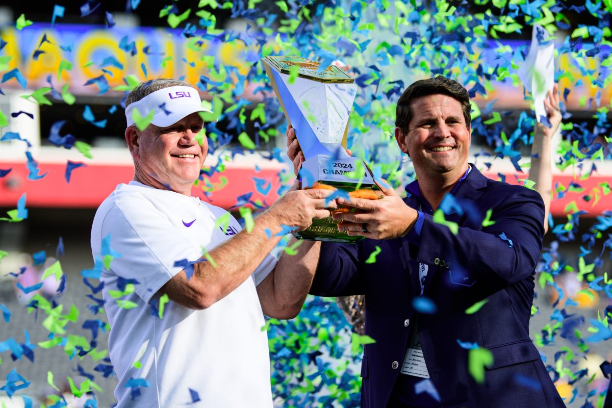 LSU football head coach Brian Kelly receives the ReliaQuest Bowl trophy on Monday, Jan. 1, 2024, after LSU's 35-31 victory against Wisconsin in Raymond James Stadium in Tampa, Fl.