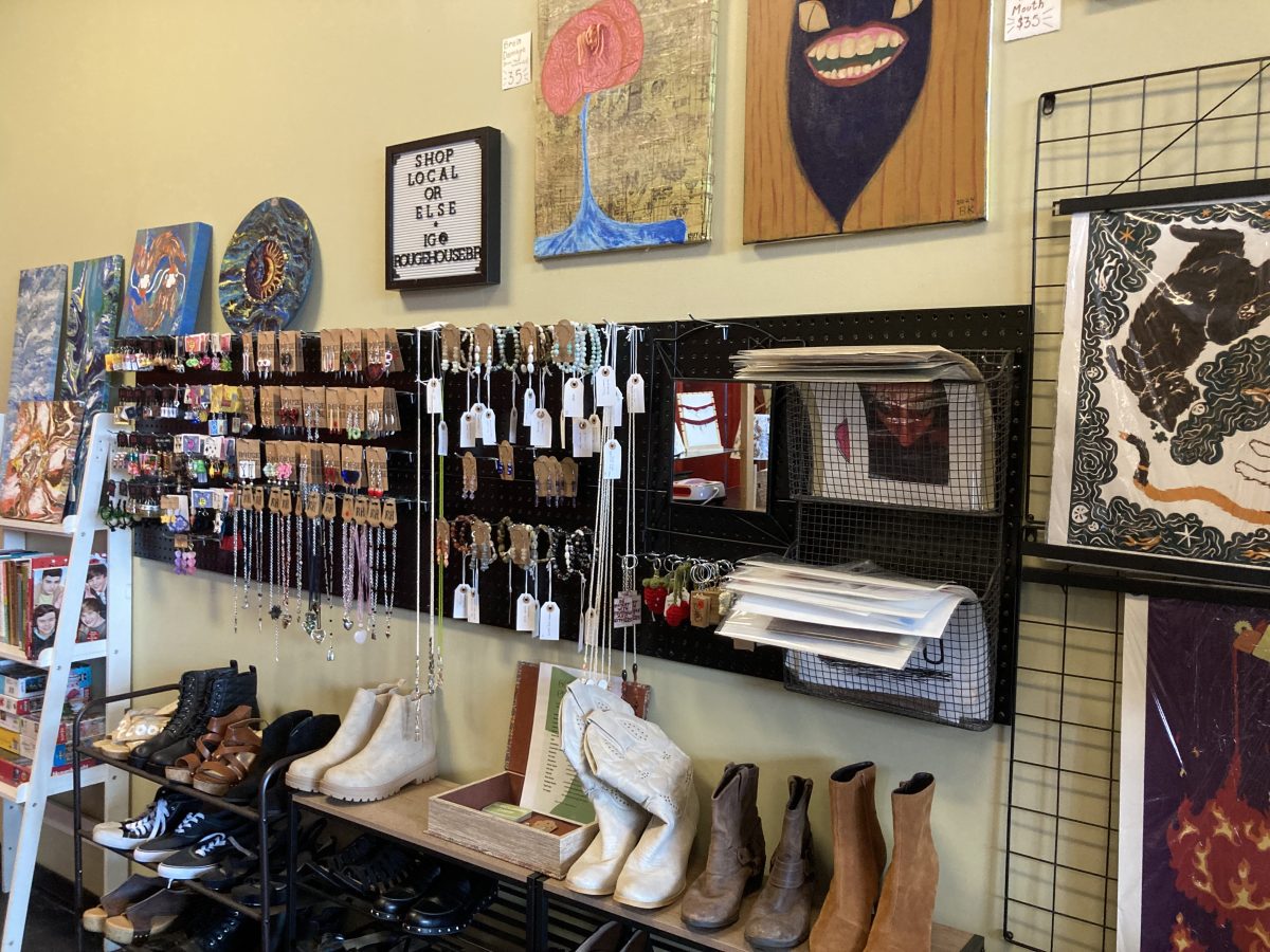 A wall of jewelry, paintings, books, shoes and other items created by vendors or donated by the public sits at Rouge House.