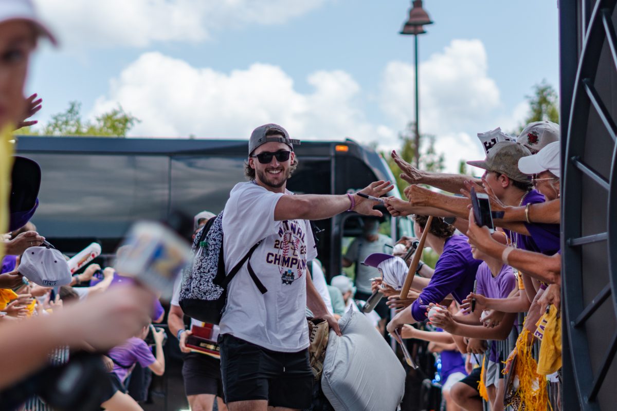 LSU baseball junior outfielder Dylan Crews (3) high fives fans on Tuesday, June 27, 2023, outside Alex Box Stadium in Baton Rouge, La.