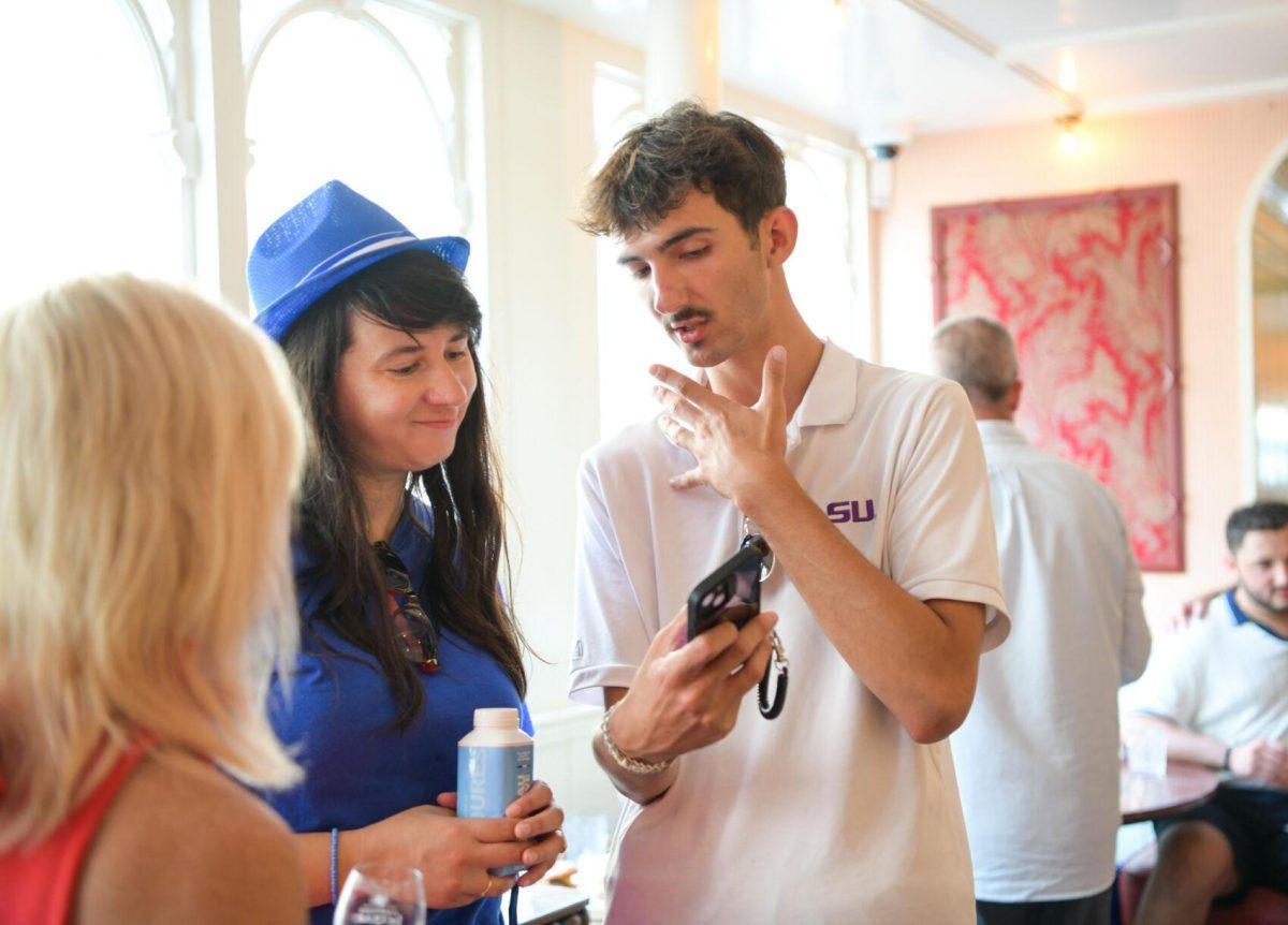 LSU mass communication Junior Ben Hagen talks to University of Florida Journalism Professor Roxane Coche about his project at Sir Winston's in Paris, France on Thursday, August 1, 2024. Thursday, August 1, 2024.