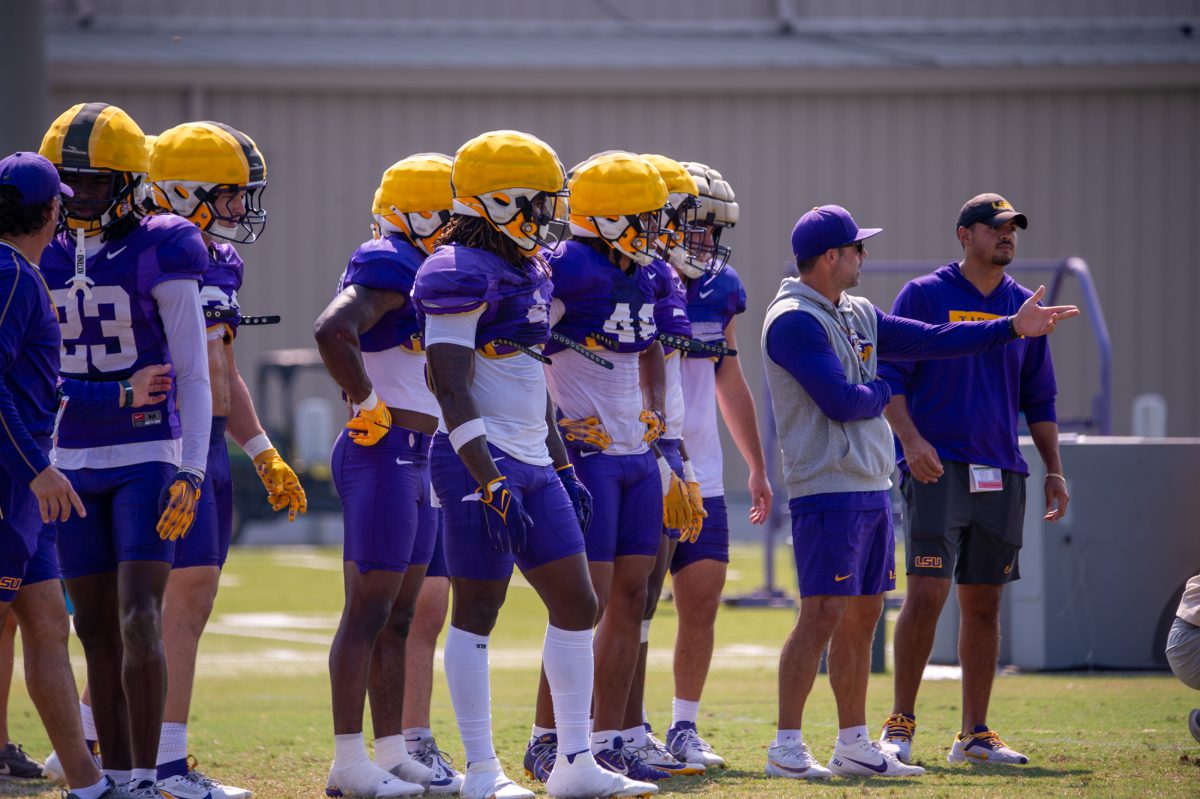 LSU football defense waits for next play along side defensive coordinator Blake Baker during the LSU Fall Camp practice on Tuesday, Aug. 13, 2024, in Baton Rouge.