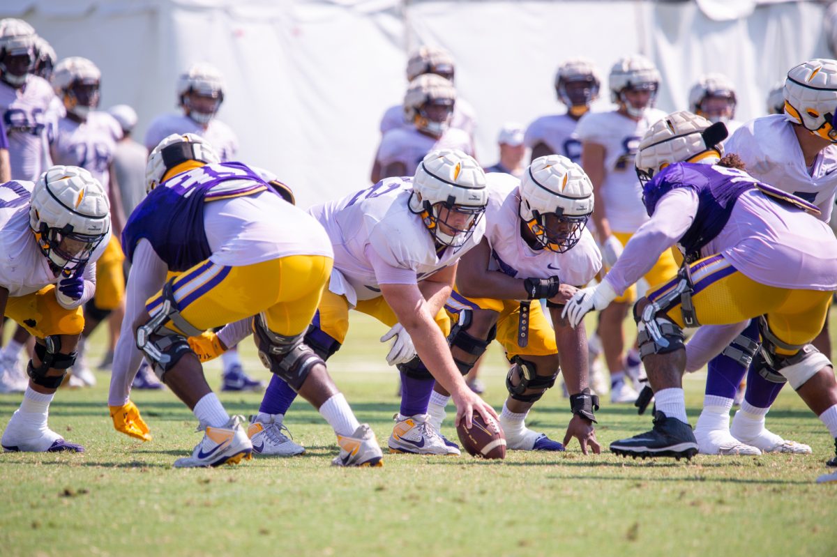 LSU football senior offensive lineman Garrett Dellinger (72) prepares to snap the ball during the LSU Fall Camp practice on Saturday, Aug. 17, 2024, in Baton Rouge.