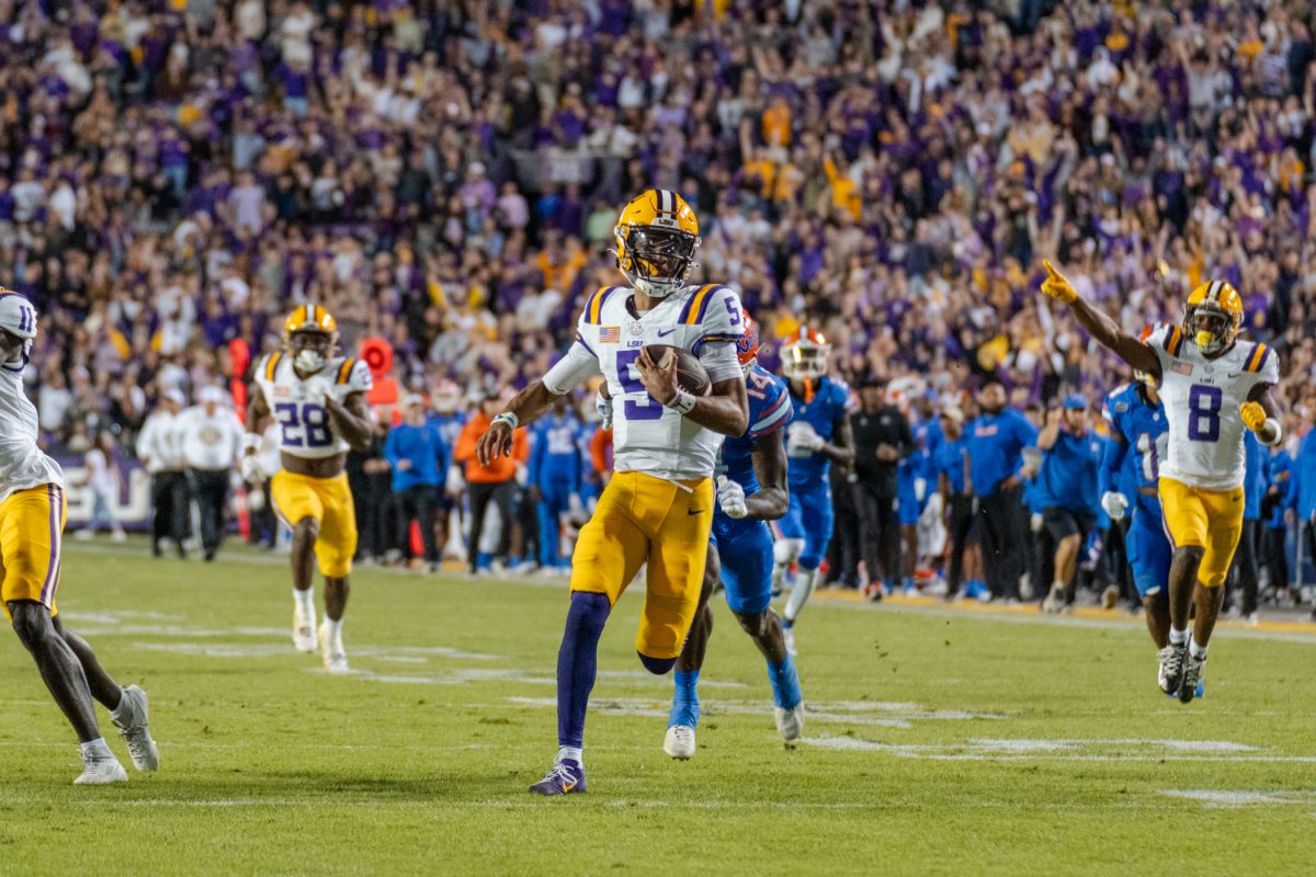 LSU football senior quarterback Jayden Daniels (5) runs toward the end zone Saturday, Nov. 11, 2023, during LSU&#8217;s 52-35 win against Florida in Tiger Stadium in Baton Rouge, La.