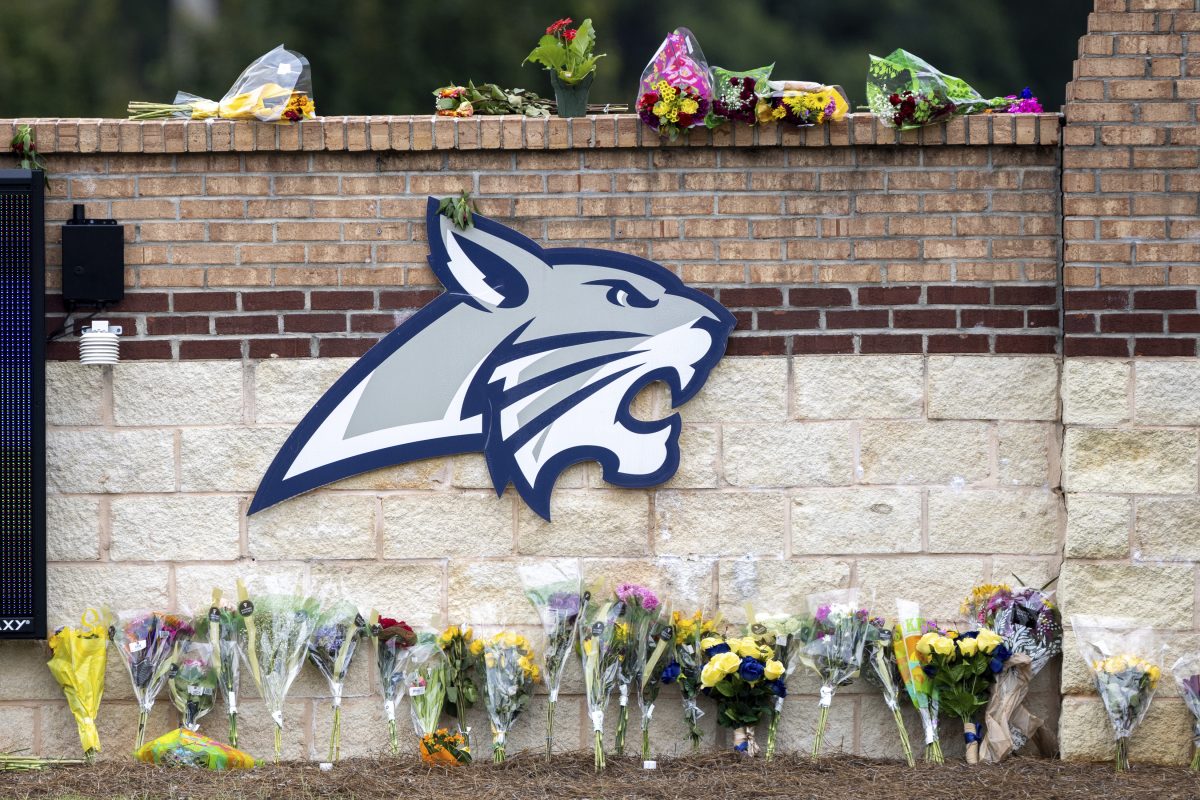 Flowers are displayed at a memorial outside Apalachee High School, Friday, Sept. 6, 2024, in Winder, Ga., following a shooting at the school earlier in the week. (Arvin Temkar/Atlanta Journal-Constitution via AP)