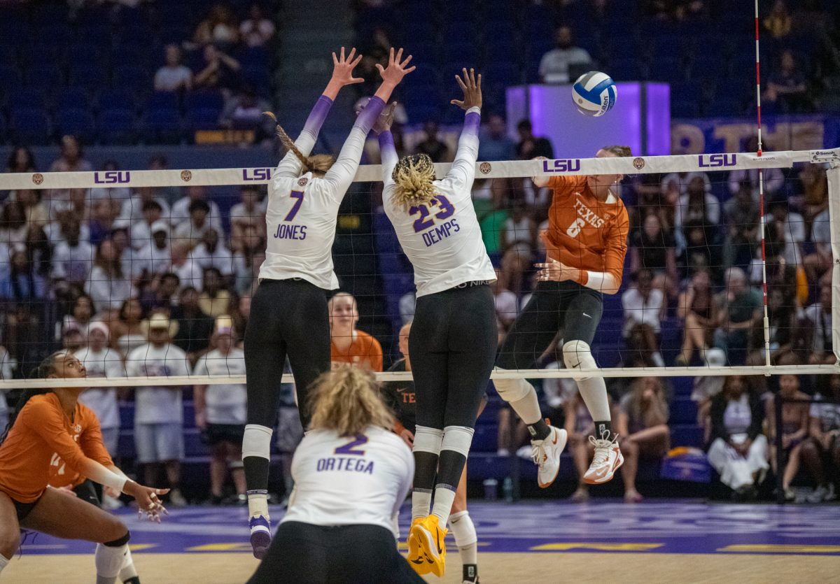 LSU volleyball freshman middle blocker Jessica Jones (7) and 5th-year-senior right side Jade Demps (23) attempt to block a hit by Texas Sunday, Sept. 29, 2024, during LSU&#8217;s 3-0 loss against Texas in the Pete Maravich Assembly Center in Baton Rouge, La.