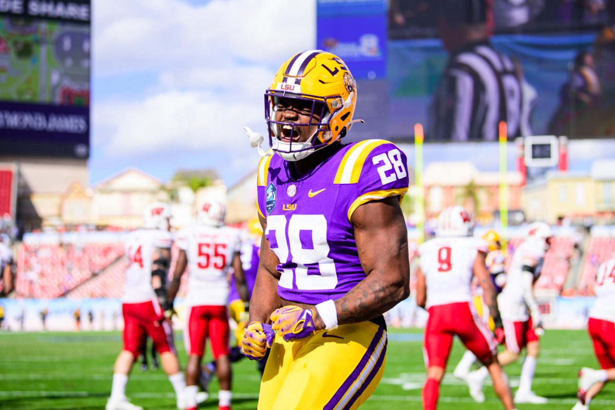 <p>LSU football freshman running back Kaleb Jackson (28) celebrates a touchdown on Monday, Jan. 1, 2024, during LSU's 35-31 victory against Wisconsin in Raymond James Stadium in Tampa, Fl.</p>