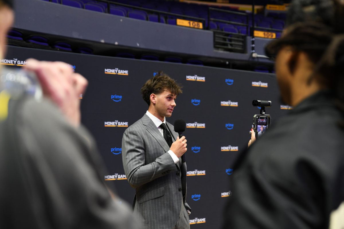 LSU men&#8217;s basketball 5th-year senior guard Trace Young speaks to an interviewer on Wednesday, Sept. 4, 2024, during the gold carpet premiere of LSU&#8217;s &#8220;The Money Game&#8221; at the Pete Maravich Assembly Center in Baton Rouge, La.