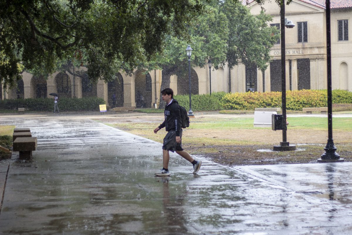 An LSU student walks through the quad during a rainy day on LSU's campus in Baton Rouge, La.