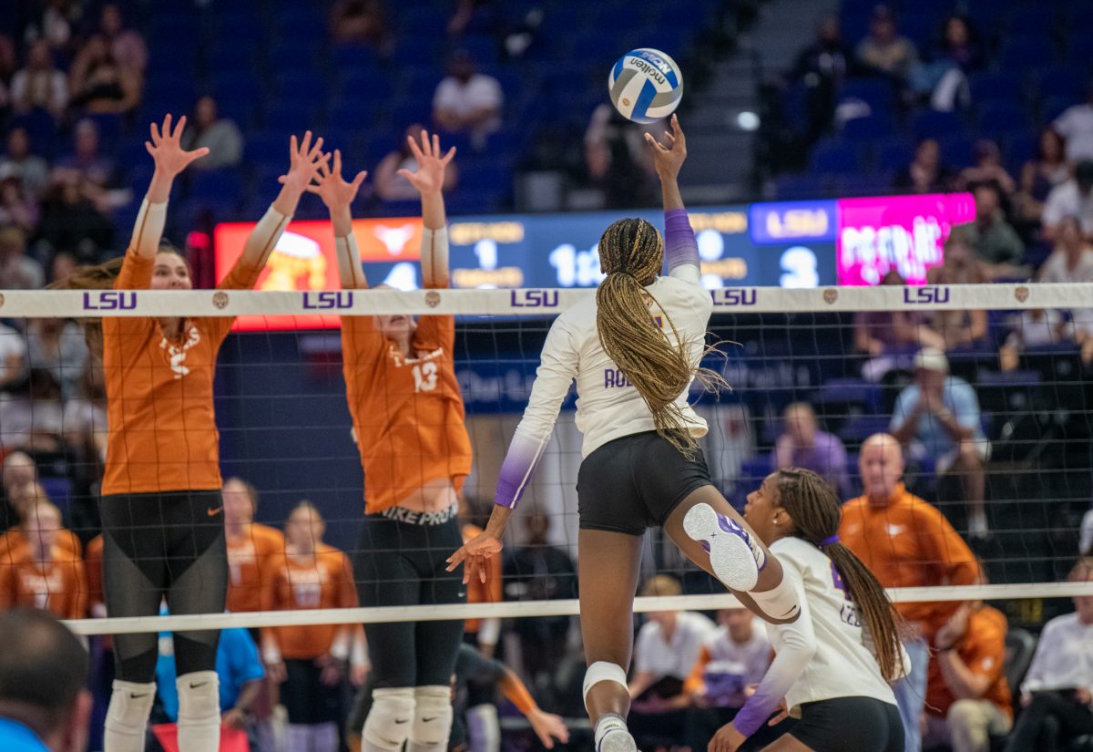 LSU volleyball sophomore outside hitter Jurnee Robinson (5) hits the ball over the net Sunday, Sept. 29, 2024, during LSU&#8217;s 3-0 loss against Texas in the Pete Maravich Assembly Center in Baton Rouge, La.