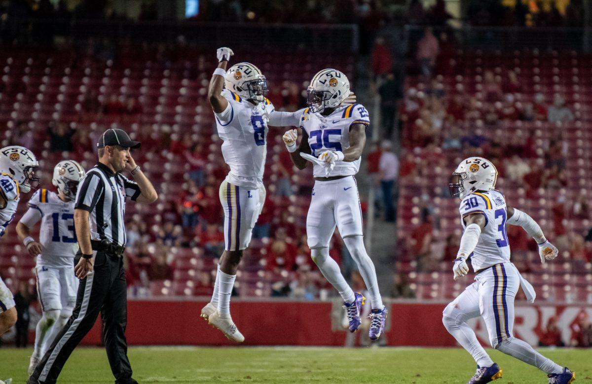 LSU football senior safety Major Burns (8) and sophomore cornerback Javien Toviano (25) celebrate Saturday, Oct. 19, 2024, during LSU&#8217;s 34-10 win against Arkansas at Donald W. Reynolds Razorback Stadium on North Razorback Road in Fayetteville, Ar.