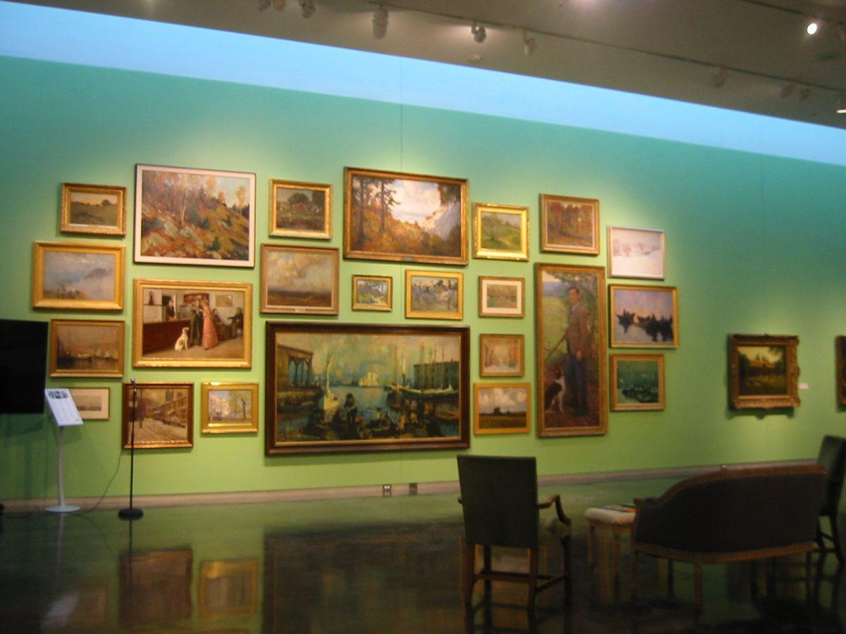 Pieces from the LSU Museum of Art In a New Light exhibit hang on the gallery wall.&#160;