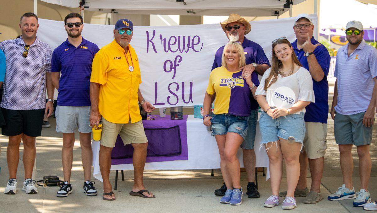 Tailgaters from &#8220;Krewe of LSU&#8221; pose for a photo at their tent Saturday, Sept. 21, 2024, before LSU&#8217;s 34-17 win against UCLA at Tiger Stadium in Baton Rouge, La.