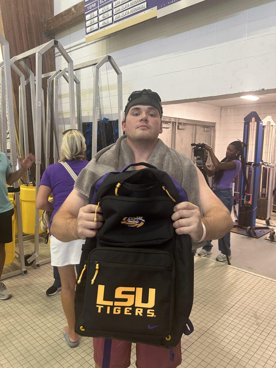 LSU Swimming and Diving cannonball contest winner, John Trap, holding competition prize.&#160;