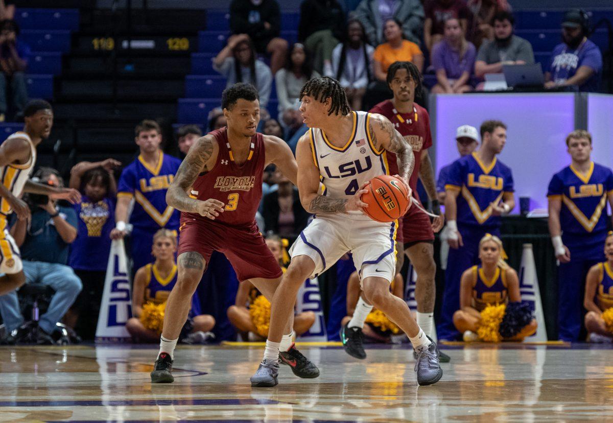 LSU men's basketball graduate student guard Dji Bailey (4) looks to pass to a teammate during LSU's 110-48 exhibition win against Loyola on Tuesday, Oct. 29, 2024, in the Pete Maravich Assembly Center in Baton Rouge, La.