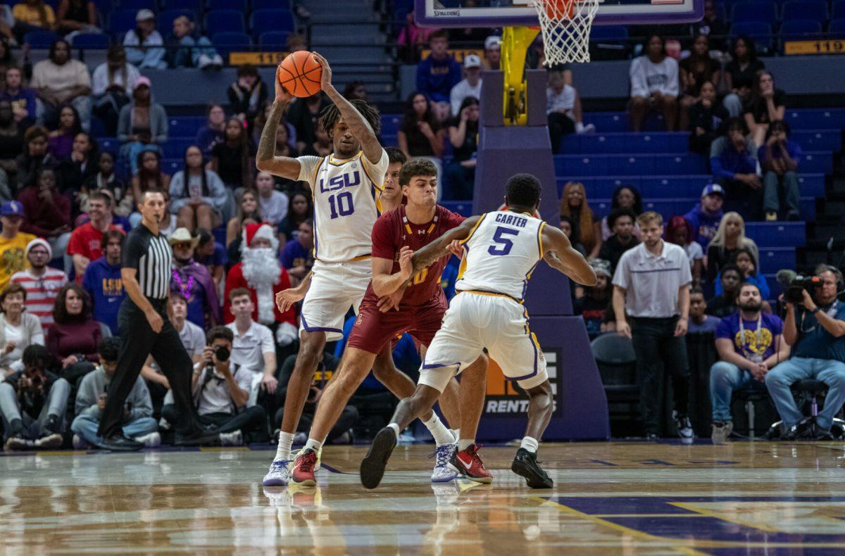 LSU men's basketball senior guard Cam Carter (5) blocks a Loyola player for redshirt junior forward Daimion Collins (10) during LSU's 110-48 exhibition win against Loyola on Tuesday, Oct. 29, 2024, in the Pete Maravich Assembly Center in Baton Rouge, La.