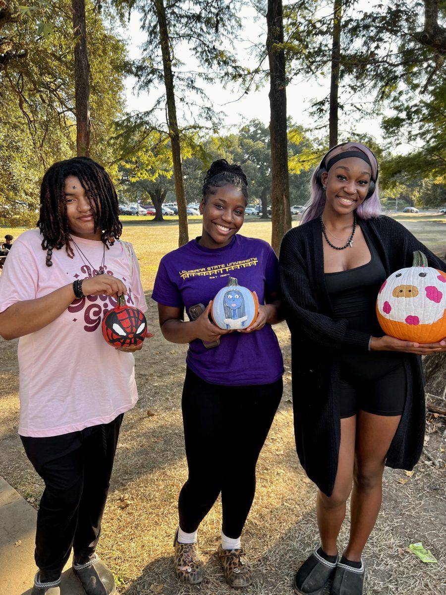 Students show off the pumpkins they painted at ASA's event on Oct. 14.