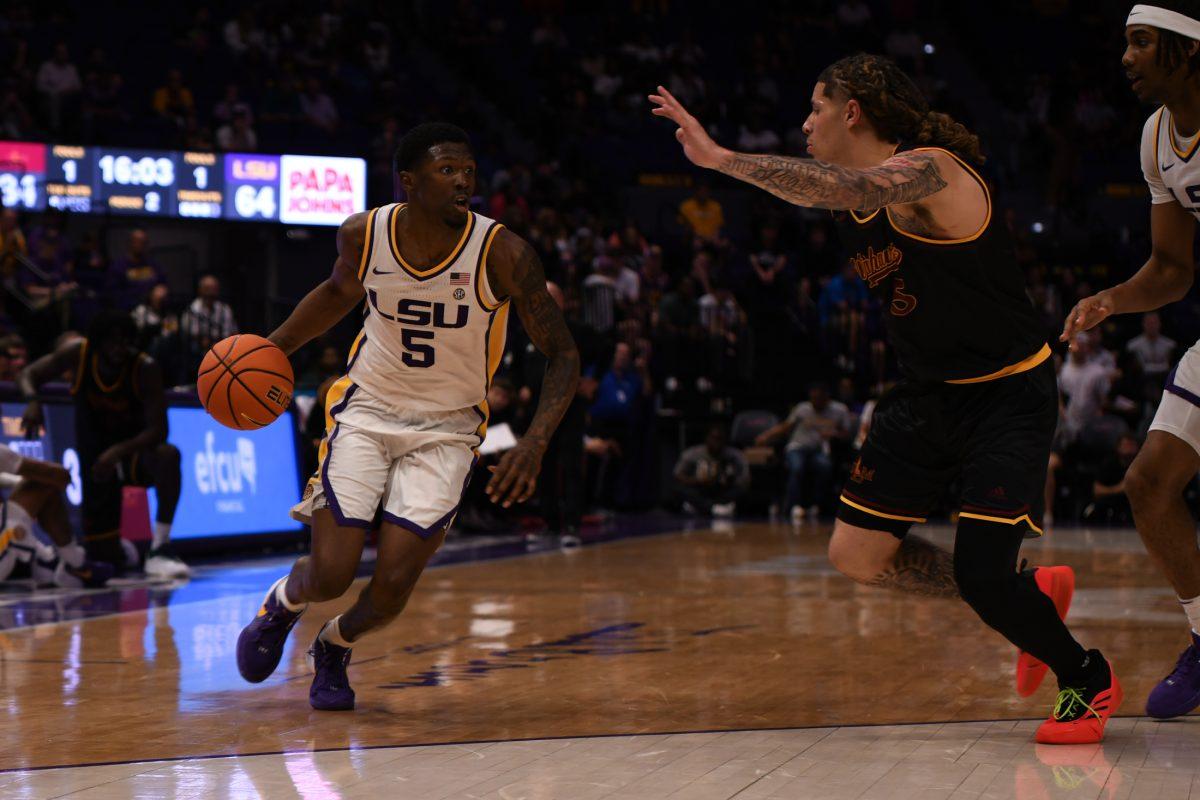 LSU men's basketball senior guard Cam Carter (5) dribbles the ball before shooting during LSU's season opening 95-60 win against University of Louisiana at Monroe on Wednesday, Nov. 6, 2024, in the Pete Maravich Assembly Center in Baton Rouge, La.