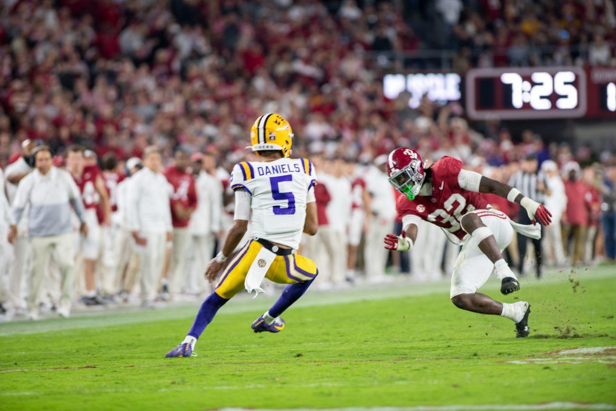 LSU football senior quarterback Jayden Daniels (5) dodges Alabama football player on Saturday, Nov. 4, 2023, during LSU's 42-28 loss against Alabama in Bryant-Denny stadium in Tuscaloosa, Al.