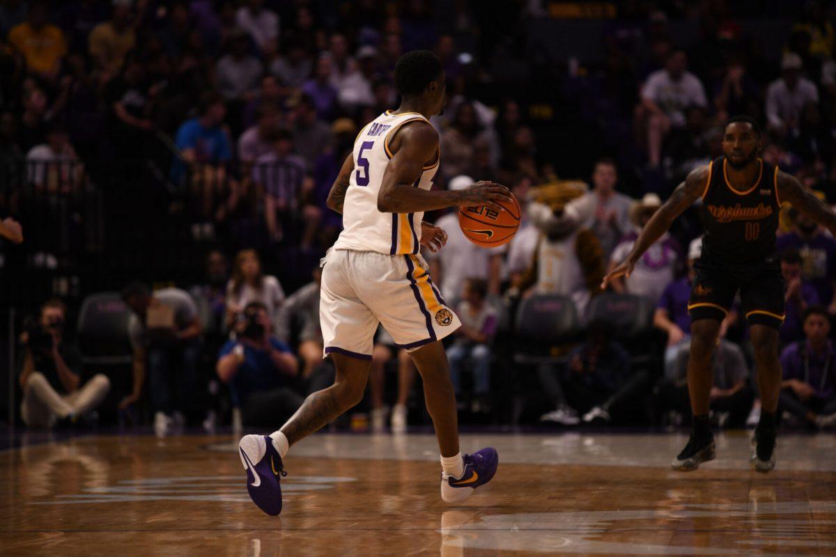 LSU men's basketball senior guard Cam Carter (5) dribbles the ball during their season opening 95-60 win against University of Louisiana at Monroe on Wednesday, Nov. 6, 2024, in the Pete Maravich Assembly Center in Baton Rouge, La.