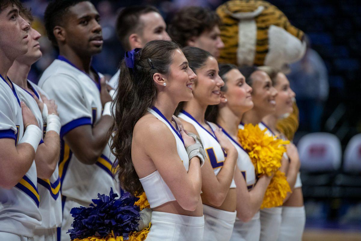 LSU cheerleaders listen to the National Anthem before LSU's 98-59 win against Troy on Monday, Nov. 18, 2024, in the Pete Maravich Assembly Center in Baton Rouge, La.