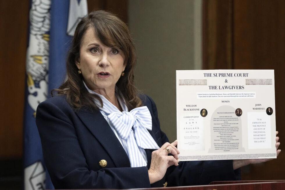 Louisiana Attorney General Liz Murrill speaks holds up a mini-display showing the Ten Commandments during a press conference regarding the Ten Commandments in schools Monday, Aug. 5, 2024, in Baton Rouge, La.&#160;