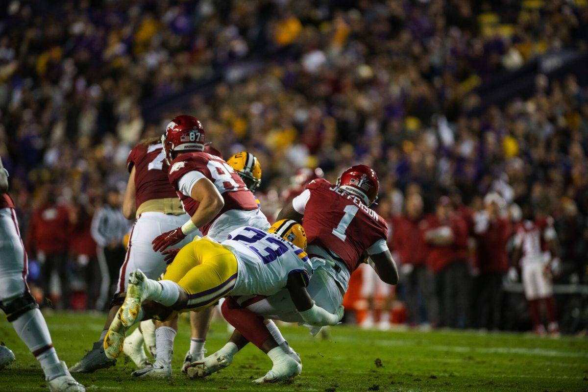 LSU football senior linebacker Micah Baskerville (23) sacks Arkansas quarterback KJ Jefferson (1) Saturday, Nov. 14, 2021, during LSU’s 16-13 loss against Arkansas at Tiger Stadium in Baton Rouge, La.