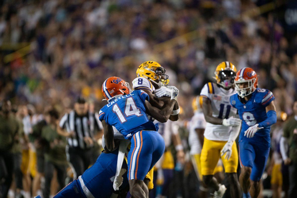 LSU football junior wide receiver Malik Nabers (8) struggles for the ball Saturday, Nov. 11, 2023, during LSU’s 52-35 win against Florida at Tiger Stadium in Baton Rouge, La.