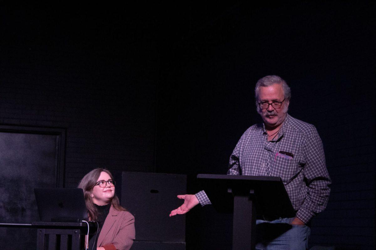 Craig Gingrich-Philbrook motions to his mentee Dr. Shelby Swafford during the Place of Performance lecture on Tuesday, Nov. 19, 2024, inside the HopKins Black Box Theater in Coates Hall.