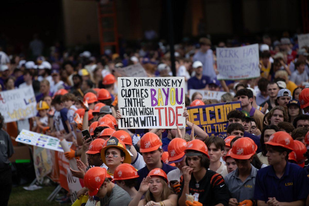 An LSU fan holds up a sign that says "I'd rather rinse my clothes in the BAYOU than wash them with TIDE" during ESPN College GameDay, Saturday, Nov. 9, 2024, in the Quad on LSU Campus in Baton Rouge, La.