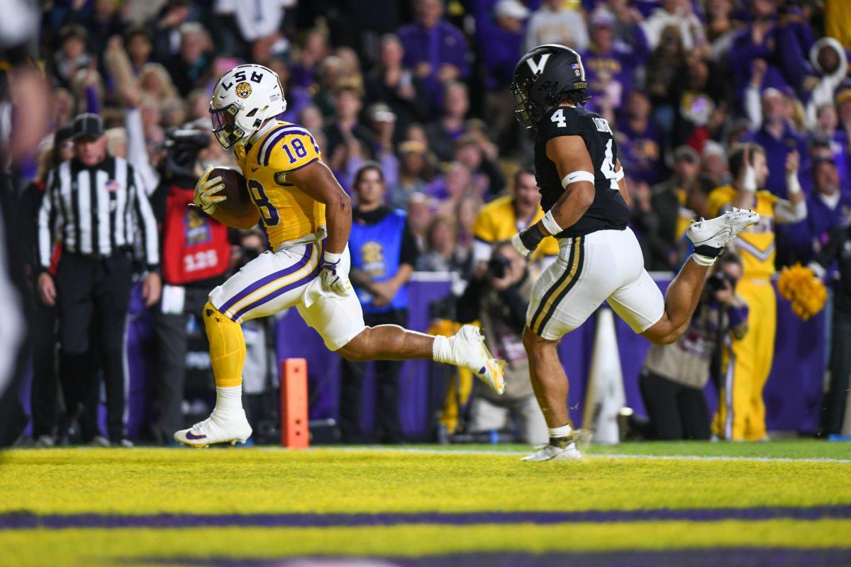 <p>LSU football graduate student running back Josh Williams (18) scores the first Tigers touchdown of the game against Vanderbilt on Nov. 23, 2024, in Tiger Stadium in Baton Rouge, La.</p>