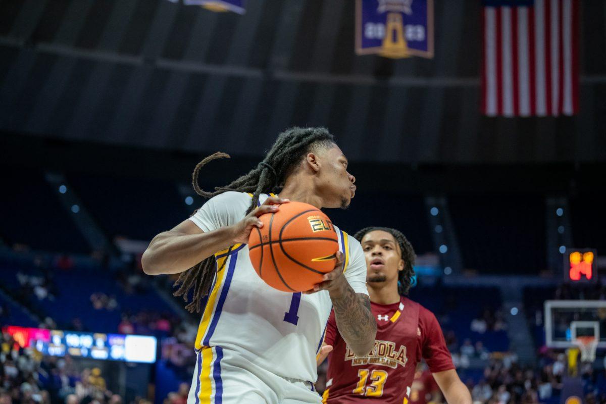 LSU men's basketball 5th-year-senior guard Jordan Sears (1) evades a block during LSU's 110-48 exhibition win against Loyola on Tuesday, Oct. 29, 2024, in the Pete Maravich Assembly Center in Baton Rouge, La.