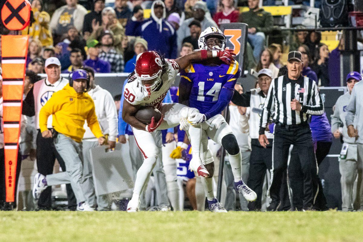 LSU football senior cornerback Zy Alexander (14) tackles the opponent Saturday, Nov. 30, 2024, during LSU's 37-17 win over Oklahoma at Tiger Stadium in Baton Rouge, La.