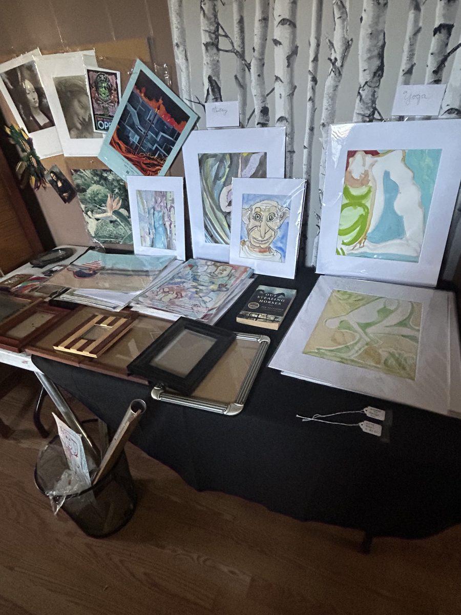 Judy Adam's artwork decorates tables at her estate sale.