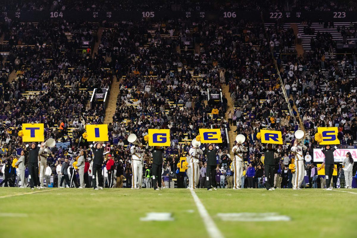 LSU cheerleaders hold up a sign that spells "tigers" on Saturday, Nov. 30, 2024, during LSU's 37-17 win over Oklahoma at Tiger Stadium in Baton Rouge, La.