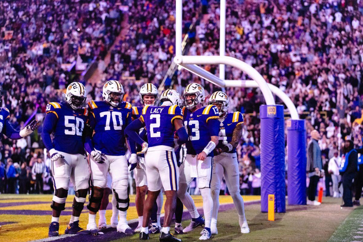 LSU football players celebrate the team's first touchdown on Saturday, Nov. 30, 2024, during LSU's 37-17 win over Oklahoma at Tiger Stadium in Baton Rouge, La.