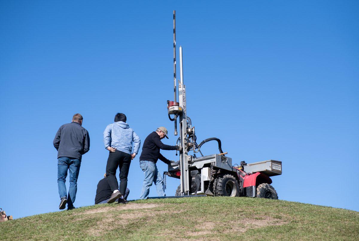 Archaeologists stand atop the Campus Mounds Monday, Dec. 2, 2024, on LSU Campus in Baton Rouge, La.