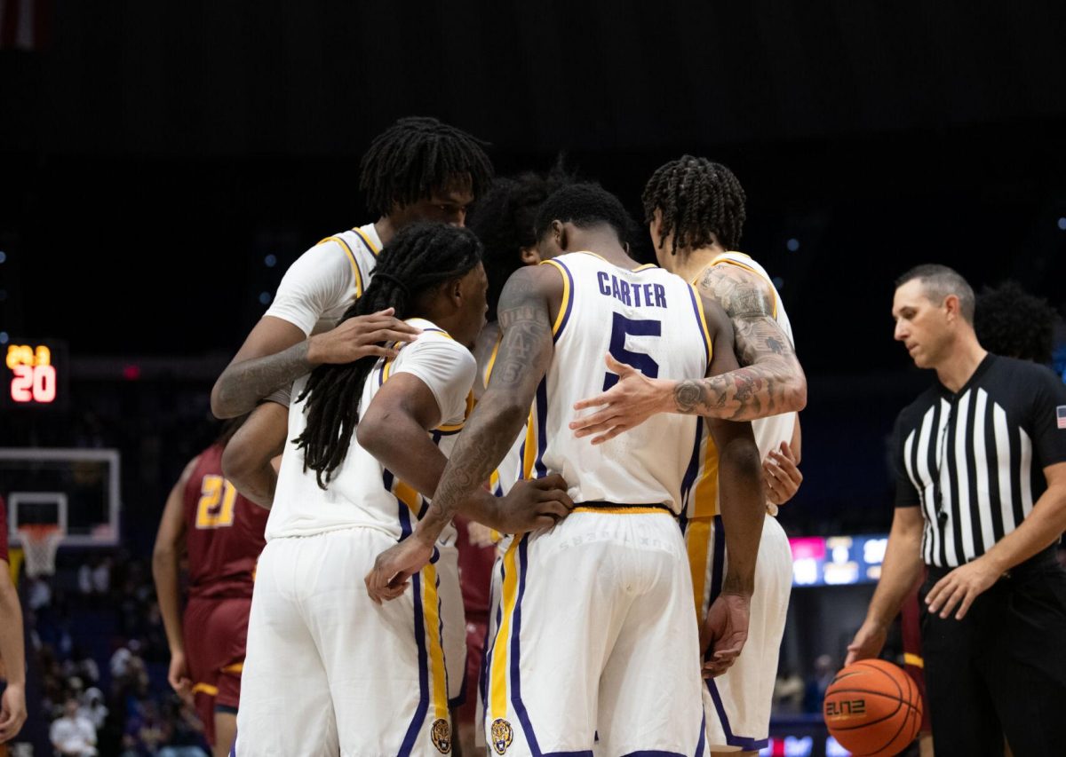 LSU men's basketball players huddle during LSU's 110-48 exhibition win against Loyola on Tuesday, Oct. 29, 2024, in the Pete Maravich Assembly Center in Baton Rouge, La.