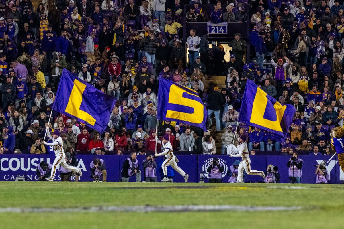 LSU cheerleaders run with LSU flags Saturday, Nov. 30, 2024, during LSU's 37-17 win over Oklahoma at Tiger Stadium in Baton Rouge, La.