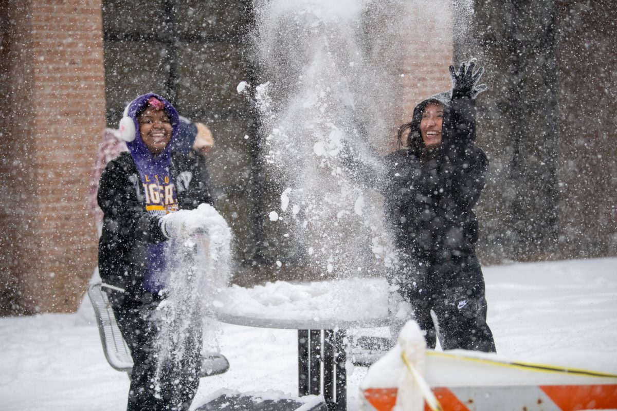 LSU students play  in the snow near North Hall on Tuesday, Jan. 21, 2025, on LSU campus in Baton Rouge, La.