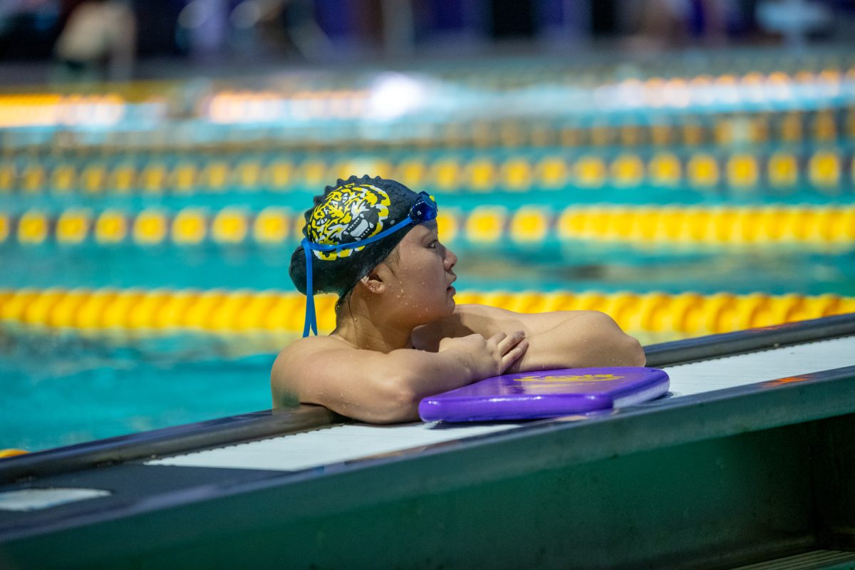 An LSU swimmer watches her teammates compete during a win against Delta State and Cincinnati on Saturday, Jan. 25, 2025, at the LSU Natatorium on West Chimes Street in Baton Rouge, La.