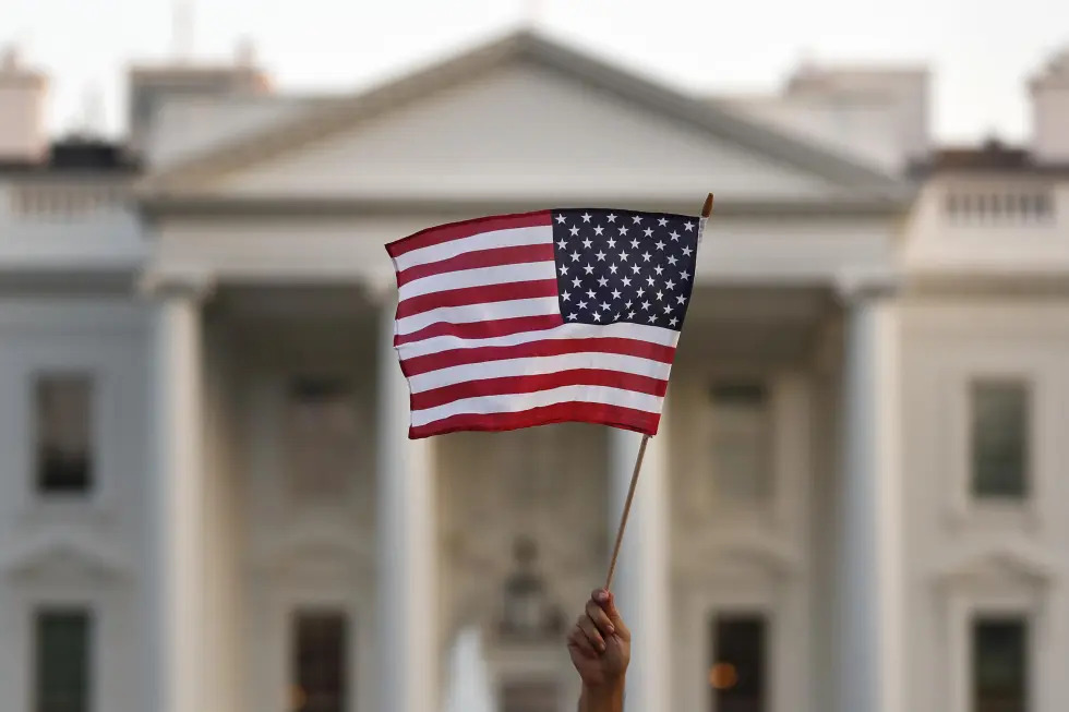 A flag is waved during an immigration rally outside the White House, in Washington, Sept. 4, 2017.